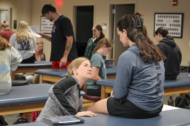 A physical therapy student works with a volunteer in the motion analysis lab.