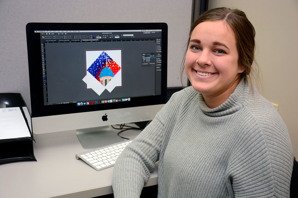 Katie Klein ’19 designing the 2018 University of Dayton Ornament