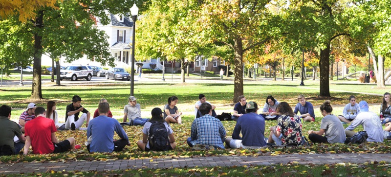 Students sitting outside in a circle