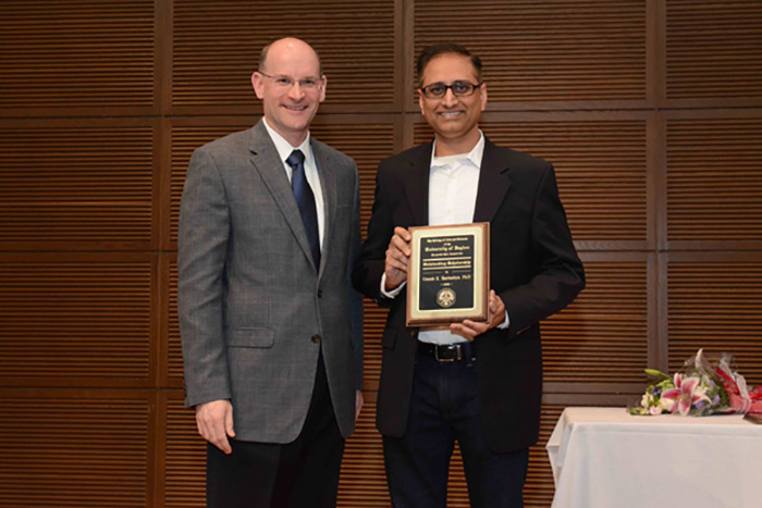 Dean Jason L. Pierce presents Umesh Haritashya the 2017 Faculty Award for Outstanding Scholarship.