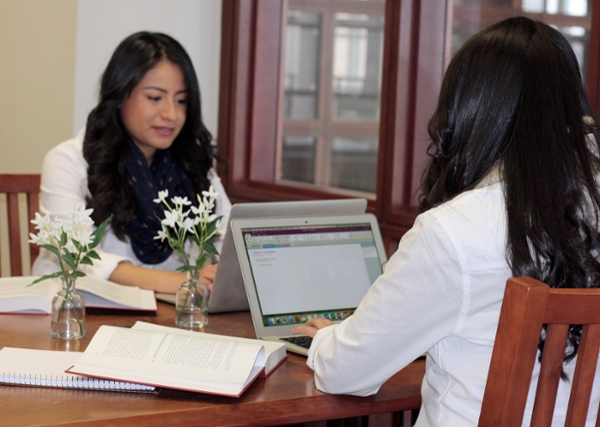Sisters Lizbeth (left) and Tammy Chavez share a special desk in the Law Library