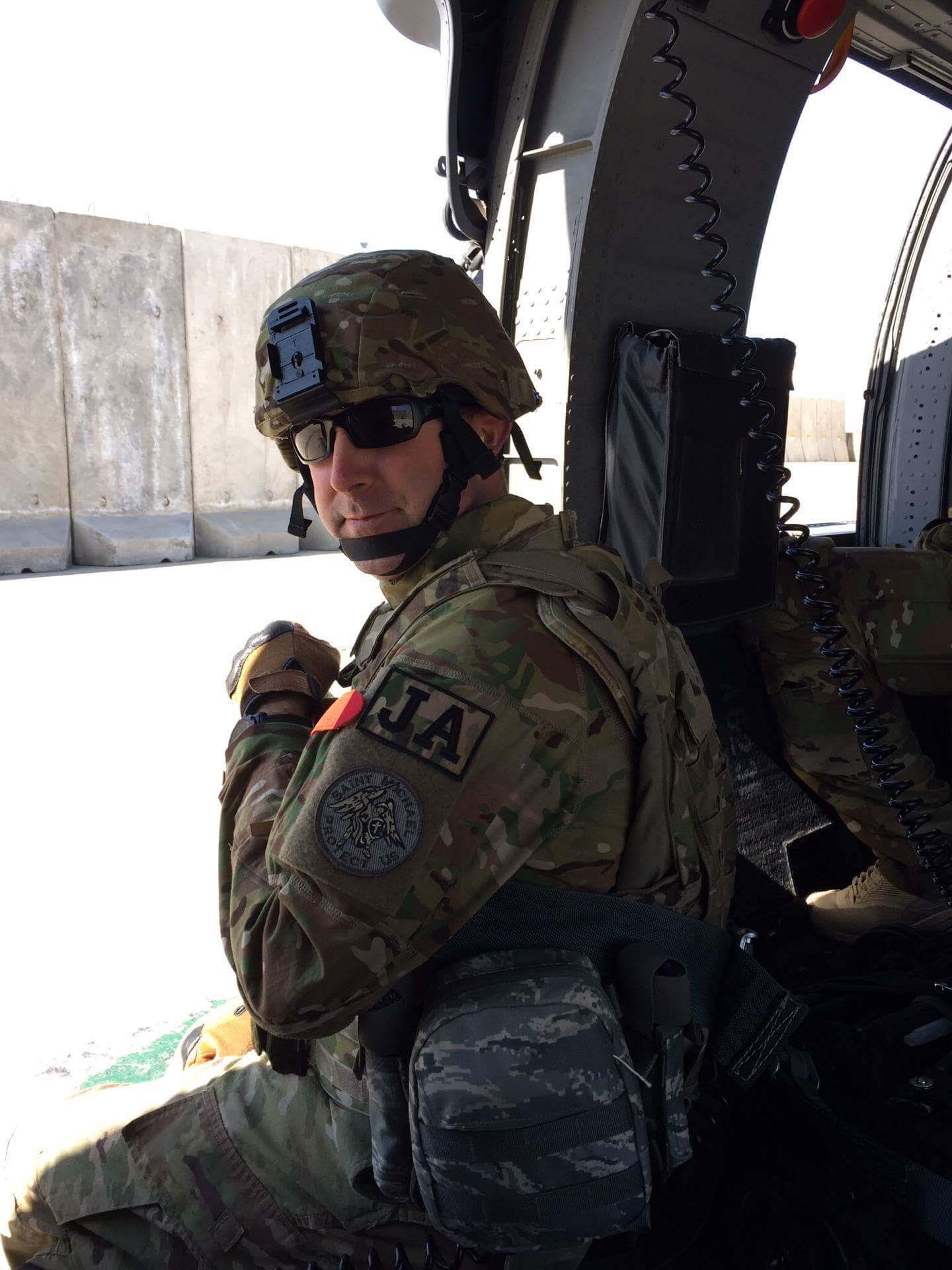 Dale Riedel in military gear in a vehicle