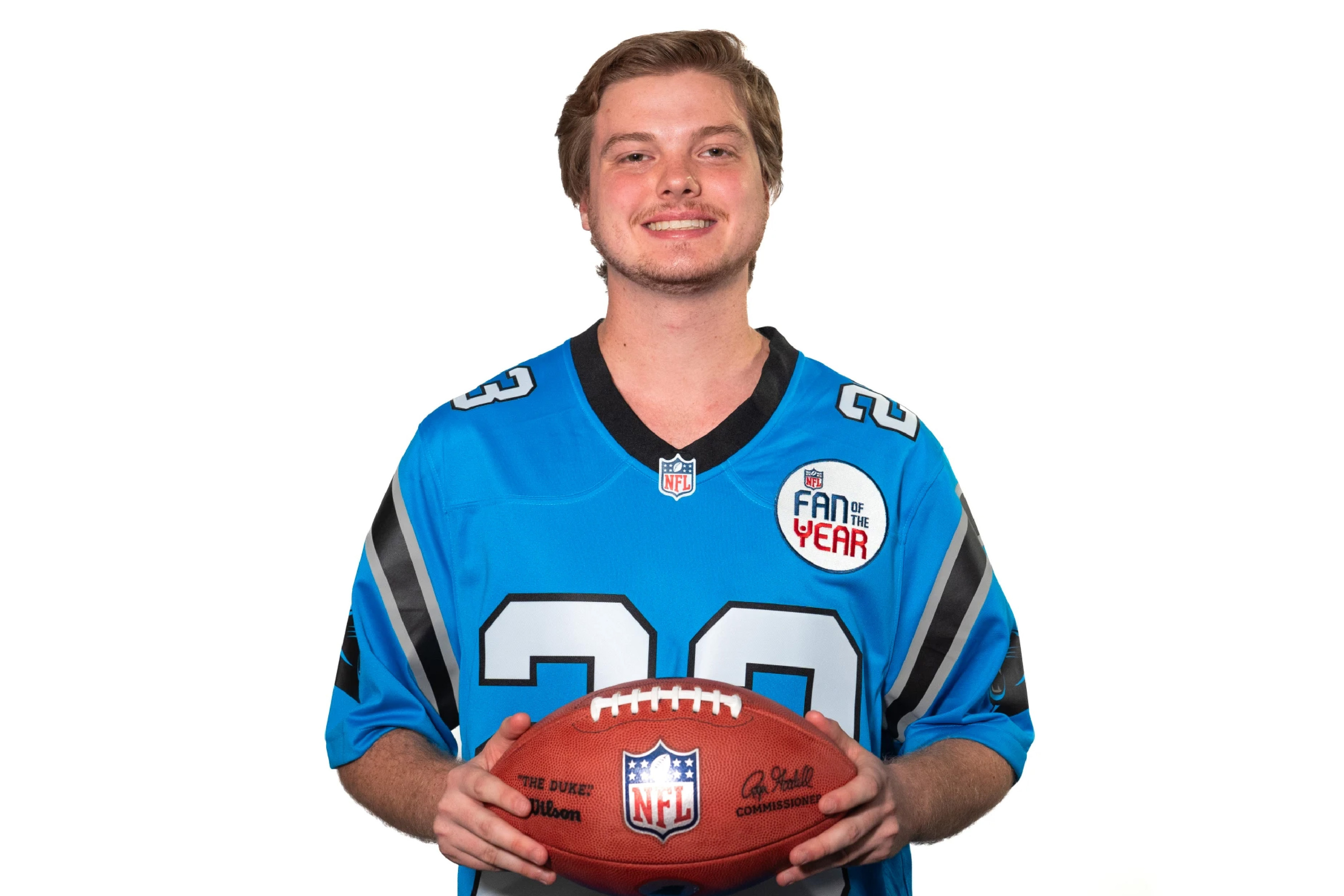 Cameron Pierson holding football and wearing a Carolina Panthers jersey.