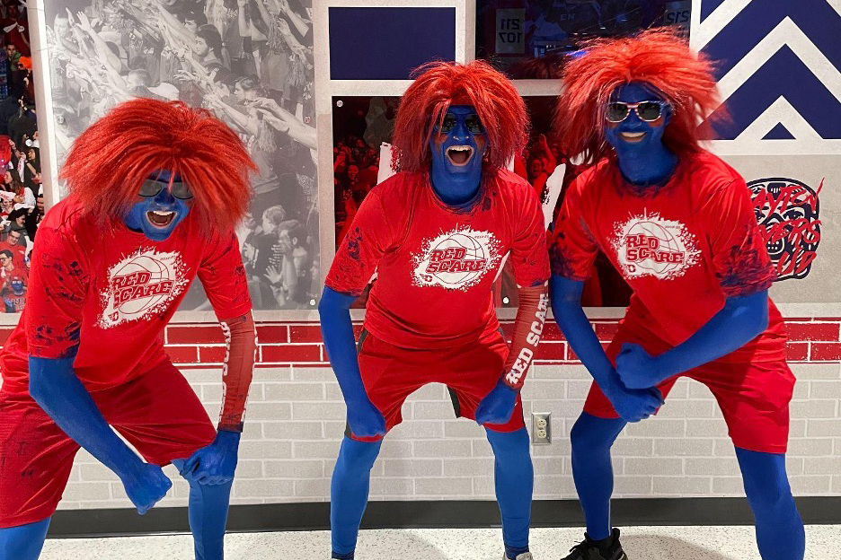 Ryan Peaco and other students with blue body paint and red wigs.