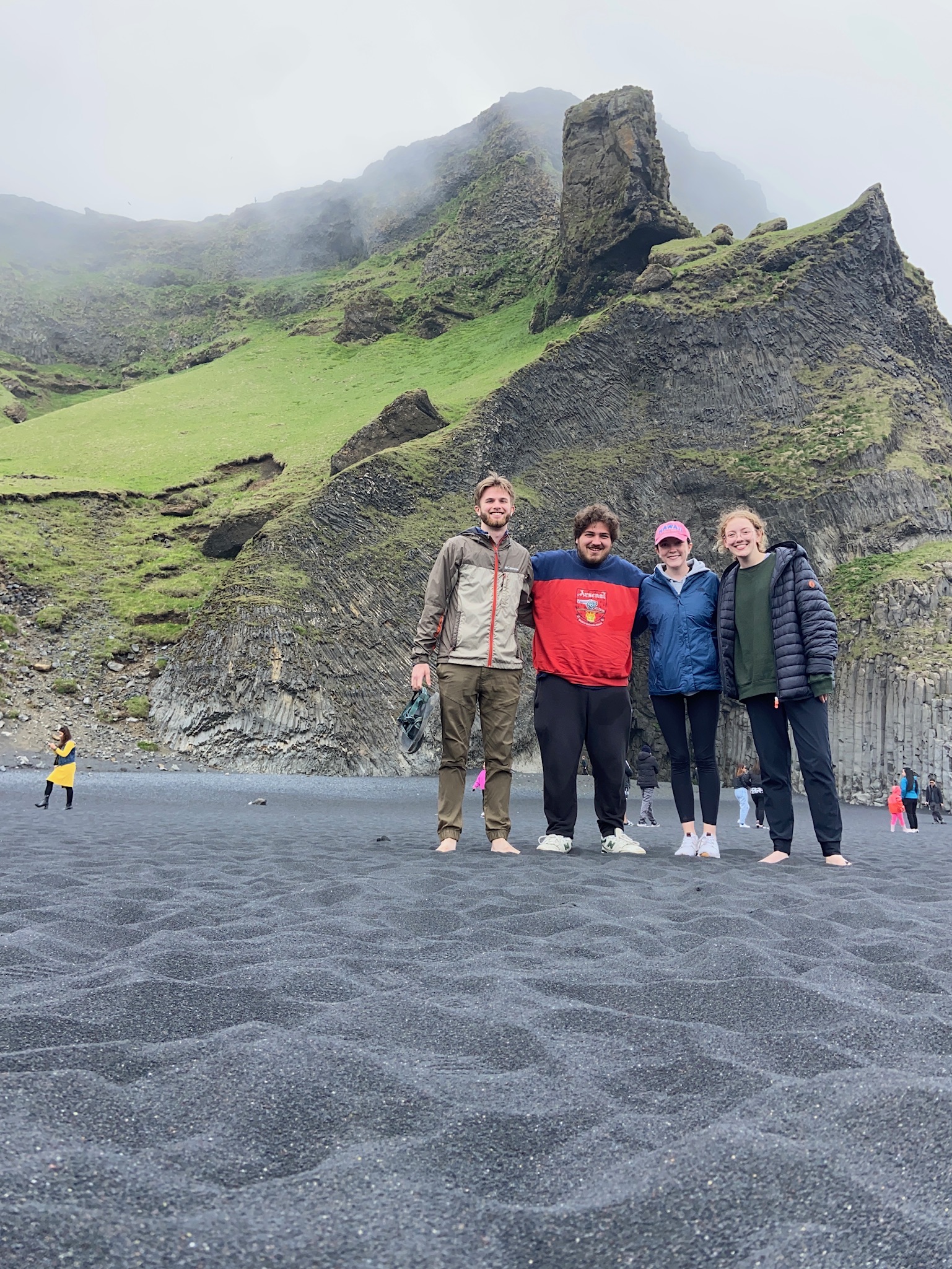 Four students standing in front of a mountain in Iceland. 