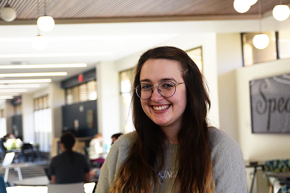 Yana Crossland sits in Roesch Library near the Dialogue Zone.