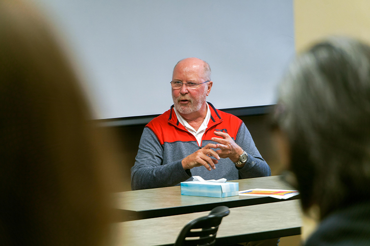 Photo of Ambassador Robert Kohorst talking to students at the University of Dayton