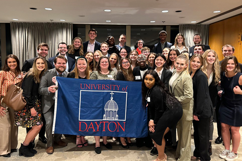 2023 Dayton2DC students pose with a UD flag.