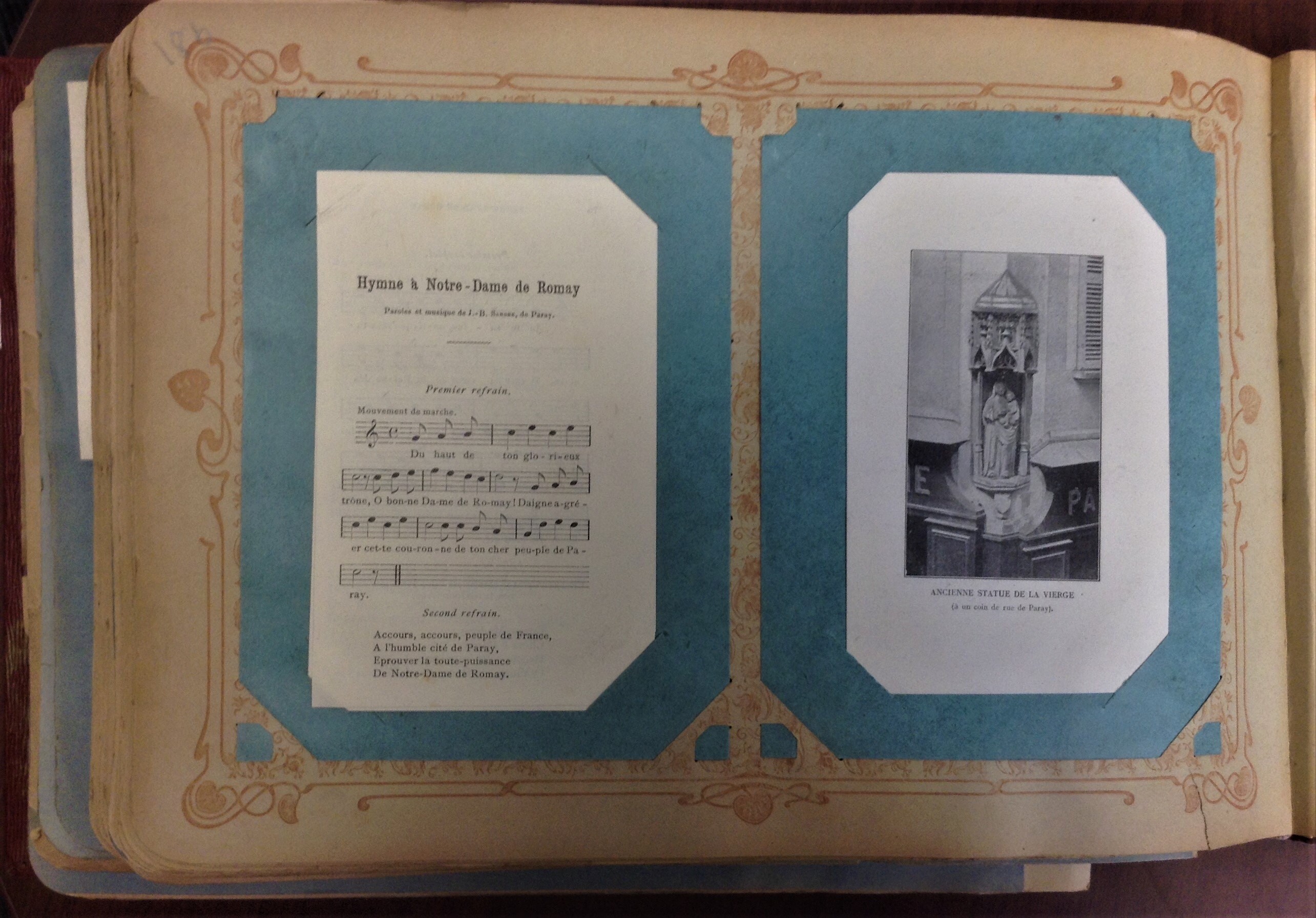 Page with hymn sheet music on the left and photograph of statue on the right