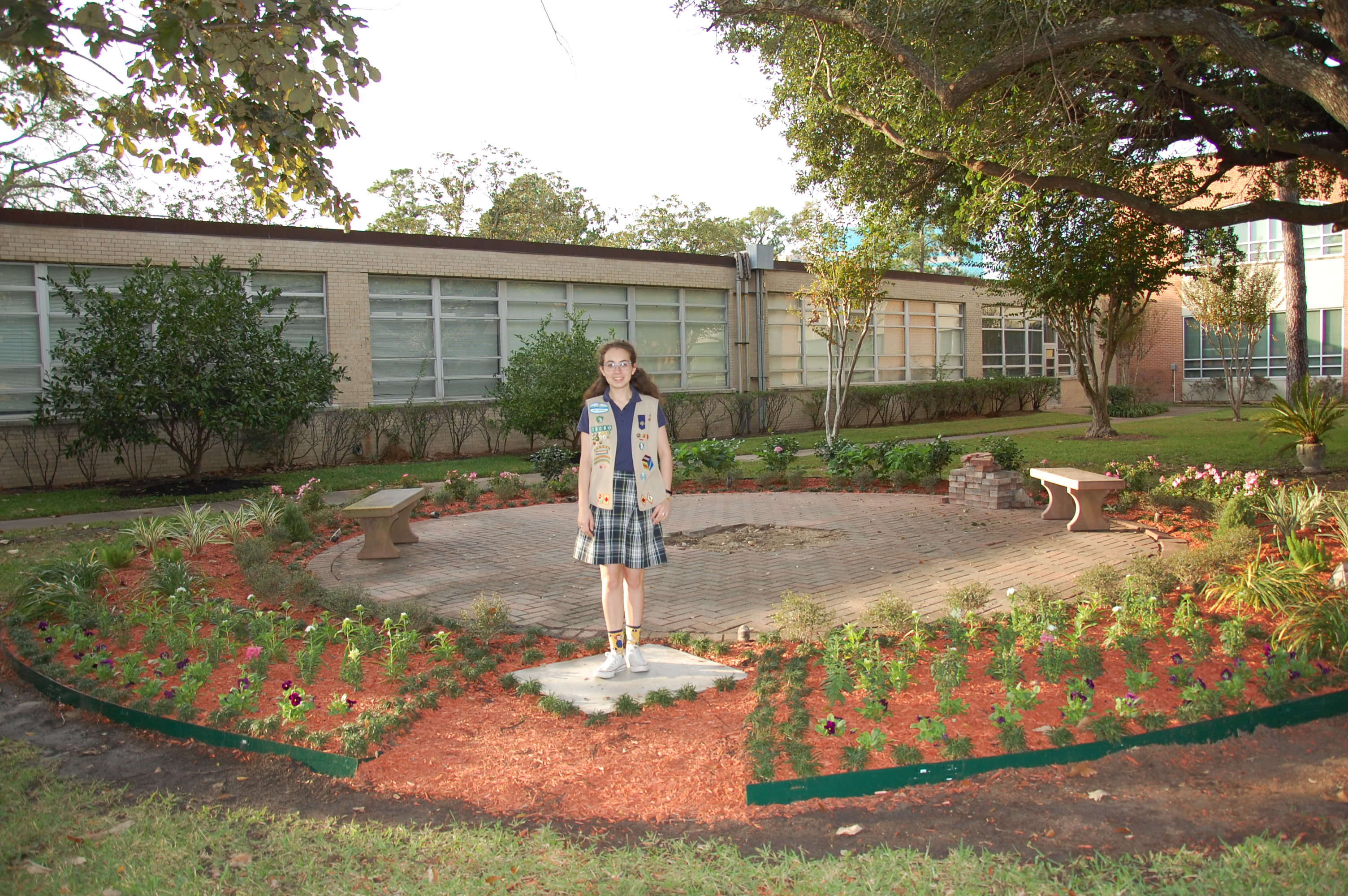 Anna McCorkle standing in the Mary garden she created for her Girl Scout Gold Award project at St. Cecilia Catholic Church in Houston, Texas.