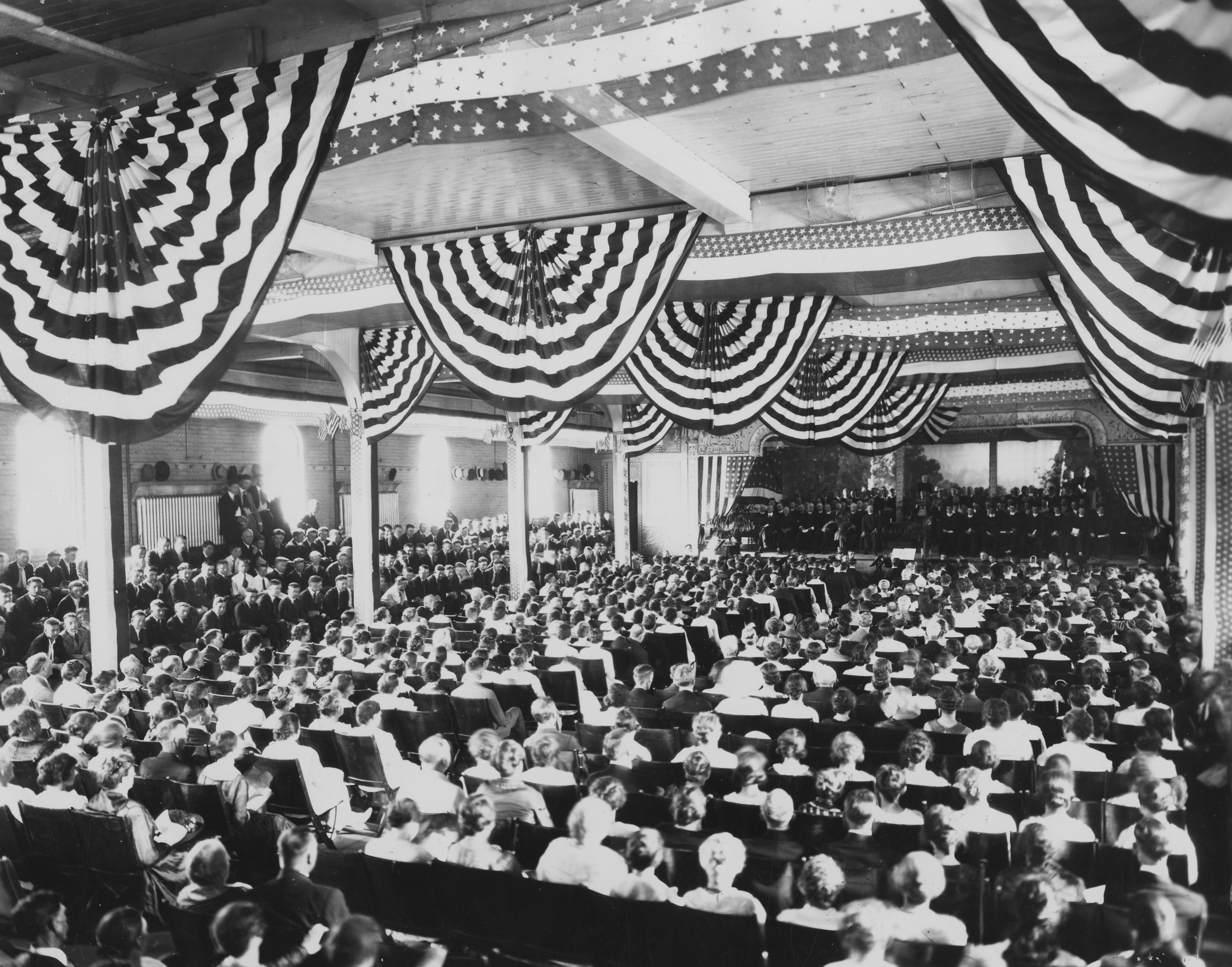 A black and white photo of an assembly inside a building