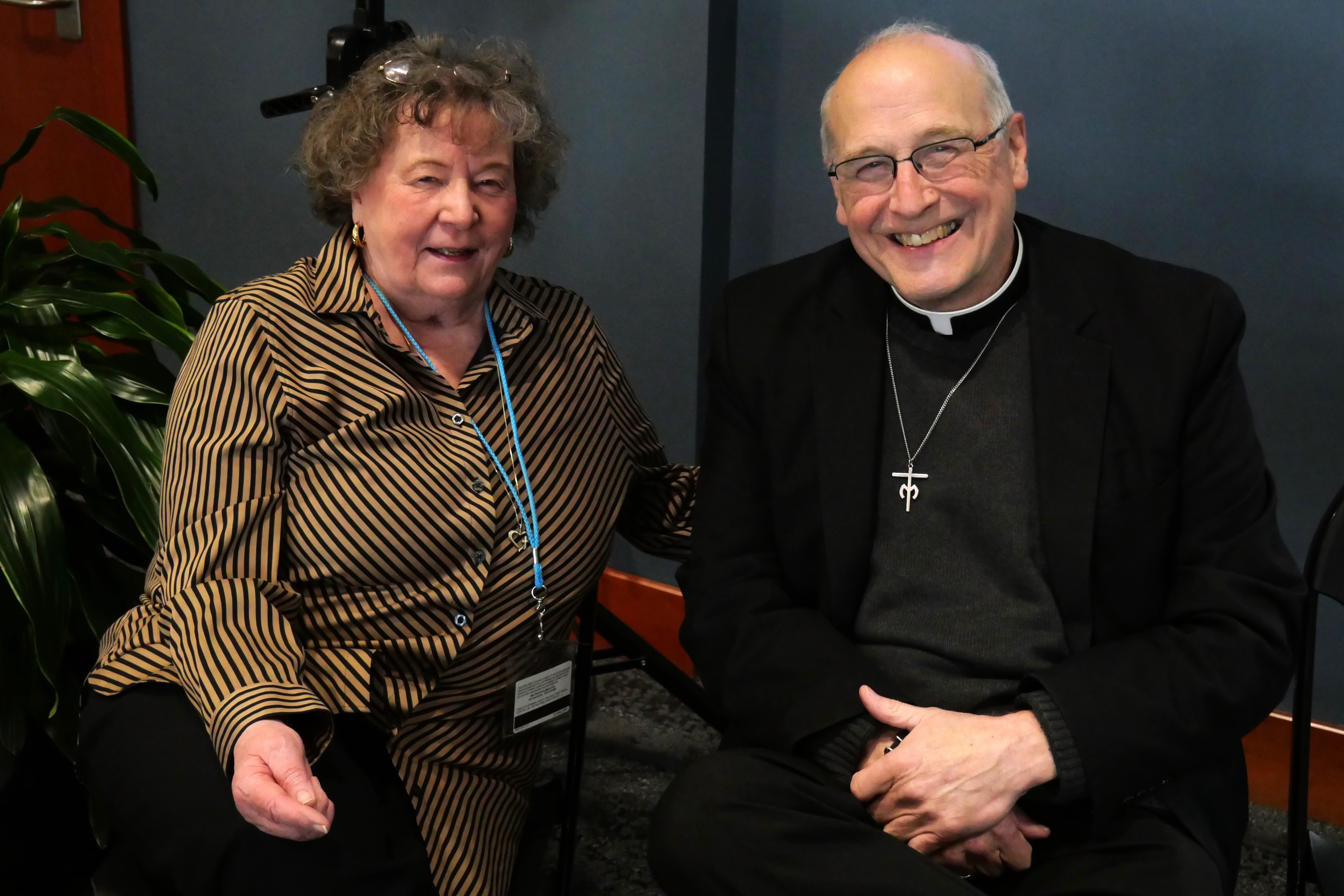 Sister Angela Ann Zukowski and Father Jim Fitz sitting together smiling