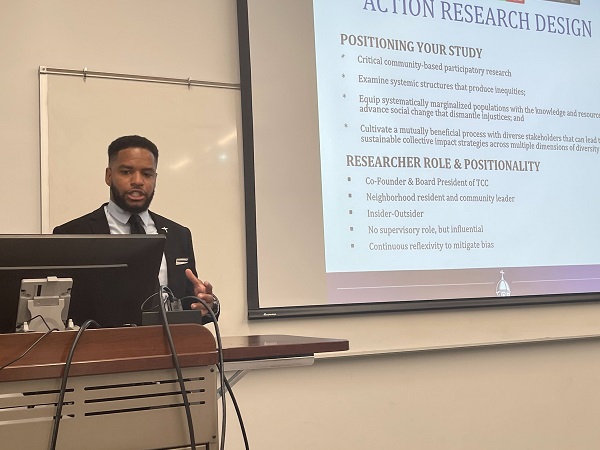 Karlos Marshall discusses his dissertation in practice with fellow cohort members.