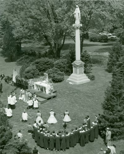 May Day 1955 at the University of Dayton; note the flowers placed at the base of the Immaculate Conception statue as part of the Marian devotion.