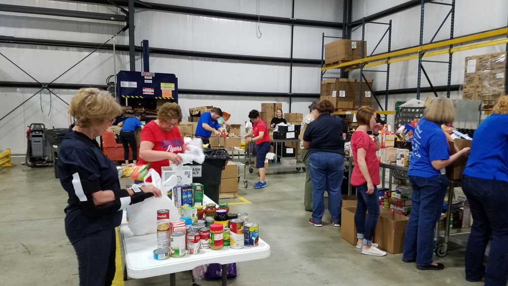 In a day of service at the Dayton Foodbank, two teams of UD volunteers (Libraries and Student Development) sort and pack foods for youth and seniors in the Dayton region.