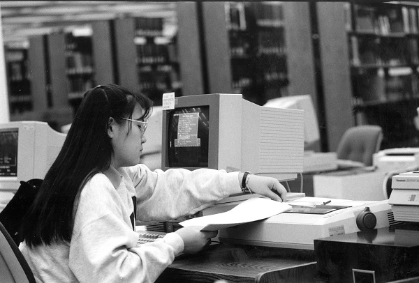 Photo of student printing a paper at a library computer