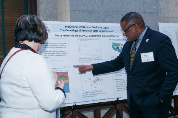 Nancy Martorano Miller, left, discusses her research with Jerome Conley, dean of the Miami University libraries, at the OhioLINK 25th anniversary celebration at the Ohio Statehouse Nov. 1. (Photo courtesy of OhioLINK)