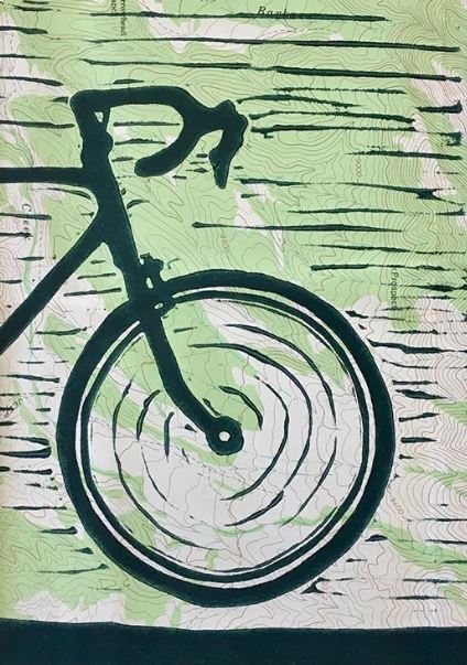 Image of a bicycle's front wheel, made from a linocut print