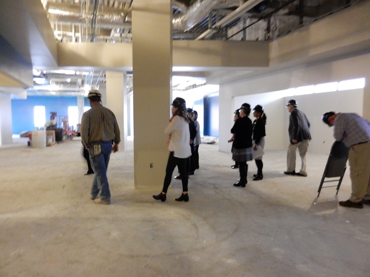 Photo of library advisory council on tour of first floor under renovation