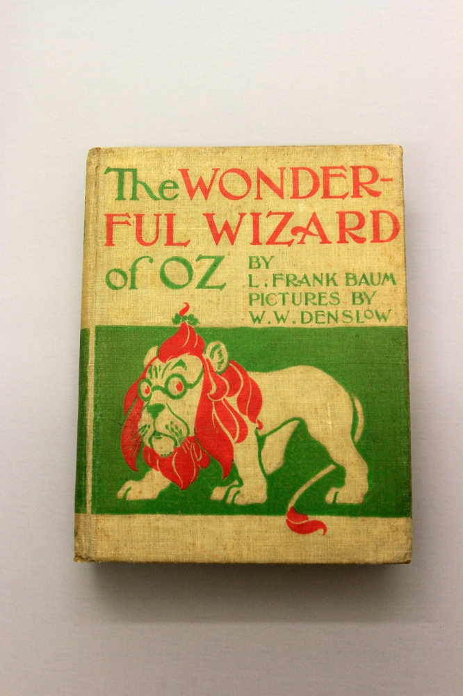 L. Frank Baum?s The Wonderful Wizard of Oz: Challenges in the 1950s and ?60s typically involved criticism of ?unwholesome and ungodly ideals? and depicting women in strong leadership roles. In the 1980s, fundamentalist Christian families argued against the depiction of benevolent witches and promoting the belief that essential human attributes were ?individually developed rather than God-given.? The item on display (1900) is a first edition and the first state of the text, plates and binding.