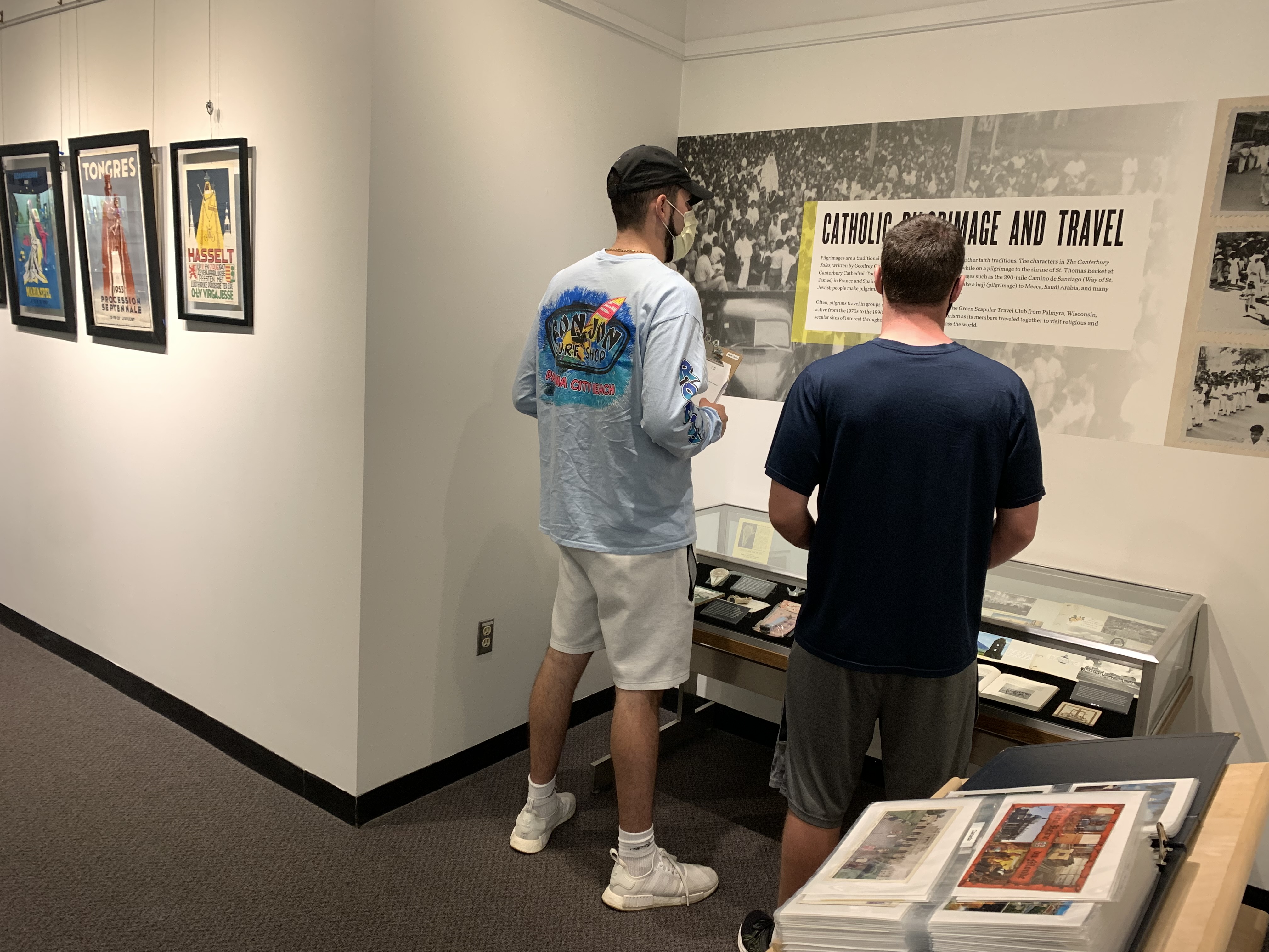 Two male students looking at an exhibit case