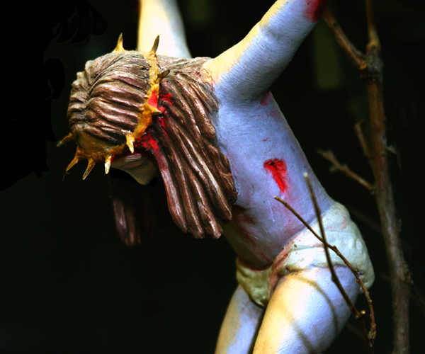 Painted clay depiction of Jesus hanging on the cross