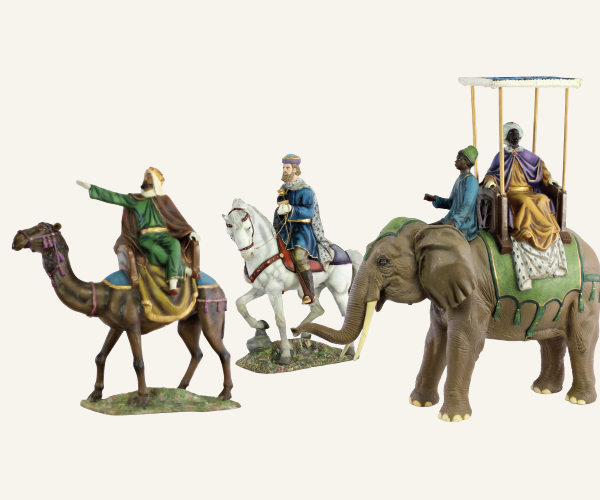 The three Magi ride on animals—one on a white horse, one on a camel, one on an elephant.