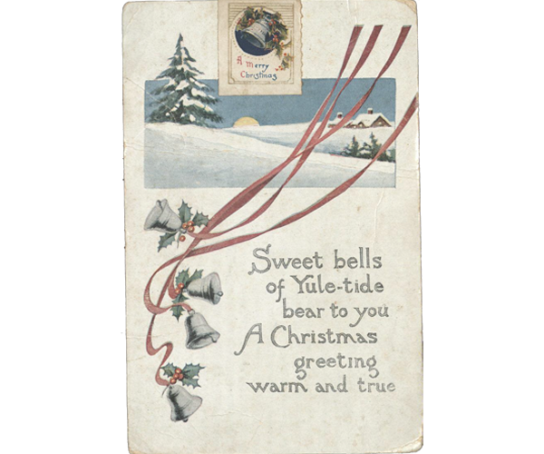 Christmas postcard featuring four silver bells decorated with holly leaves and berries and long red ribbons. A winter landscape in the background contains evergreen trees, a yellow sun against a blue horizon, and a snow-covered farmhouse set at a distance from the snowy hills in the foreground. A Christmas message is printed to the right of the bells: “Sweet bells of Yule-tide bear to you A Christmas greeting warm and true.” Above the sun in the image is a Christmas stamp featuring a silver bell decorated with holly leaves and berries set in a navy blue circle with the message: “A Merry Christmas” printed in red and blue below the image.