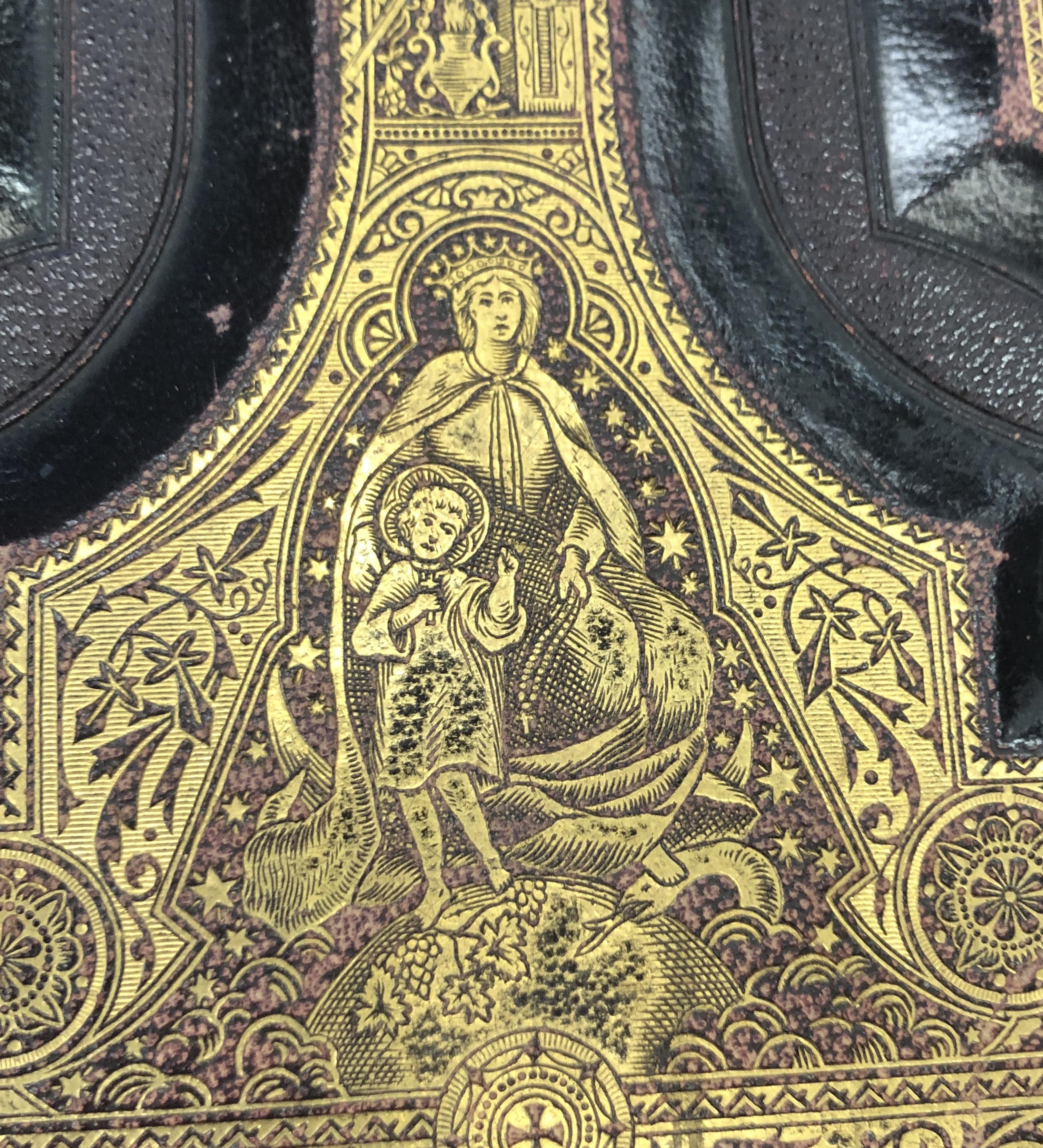 Although the Bible is a gigantic, weighty object, it still bears fine details like this gilt Mary and Jesus. 