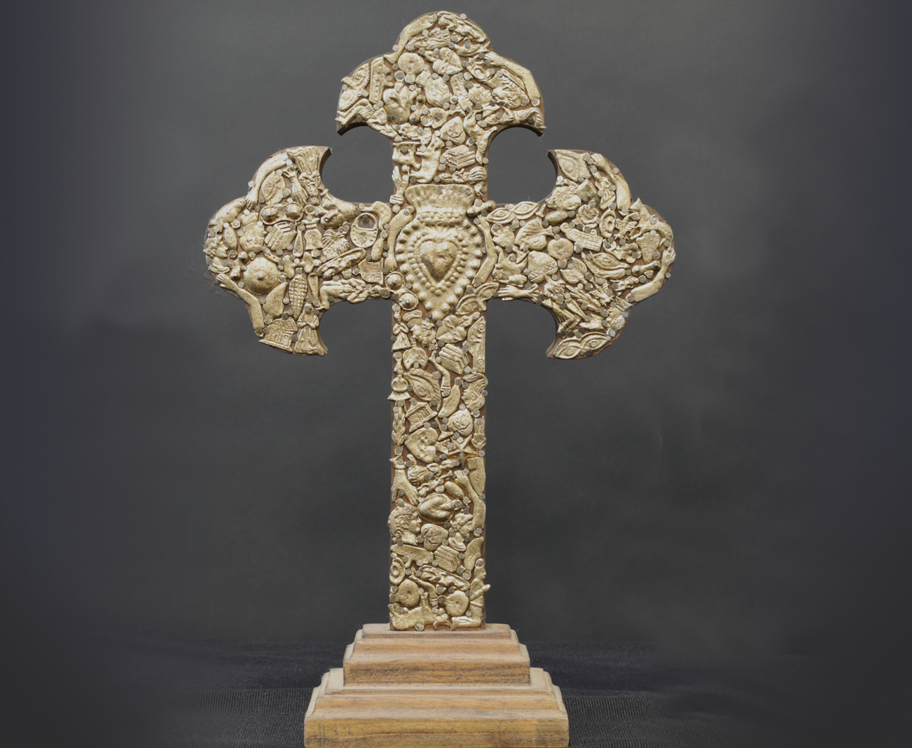 Cross from Mexico containing over 130 charms. The central charm is a symbol for Mary’s Immaculate Heart.