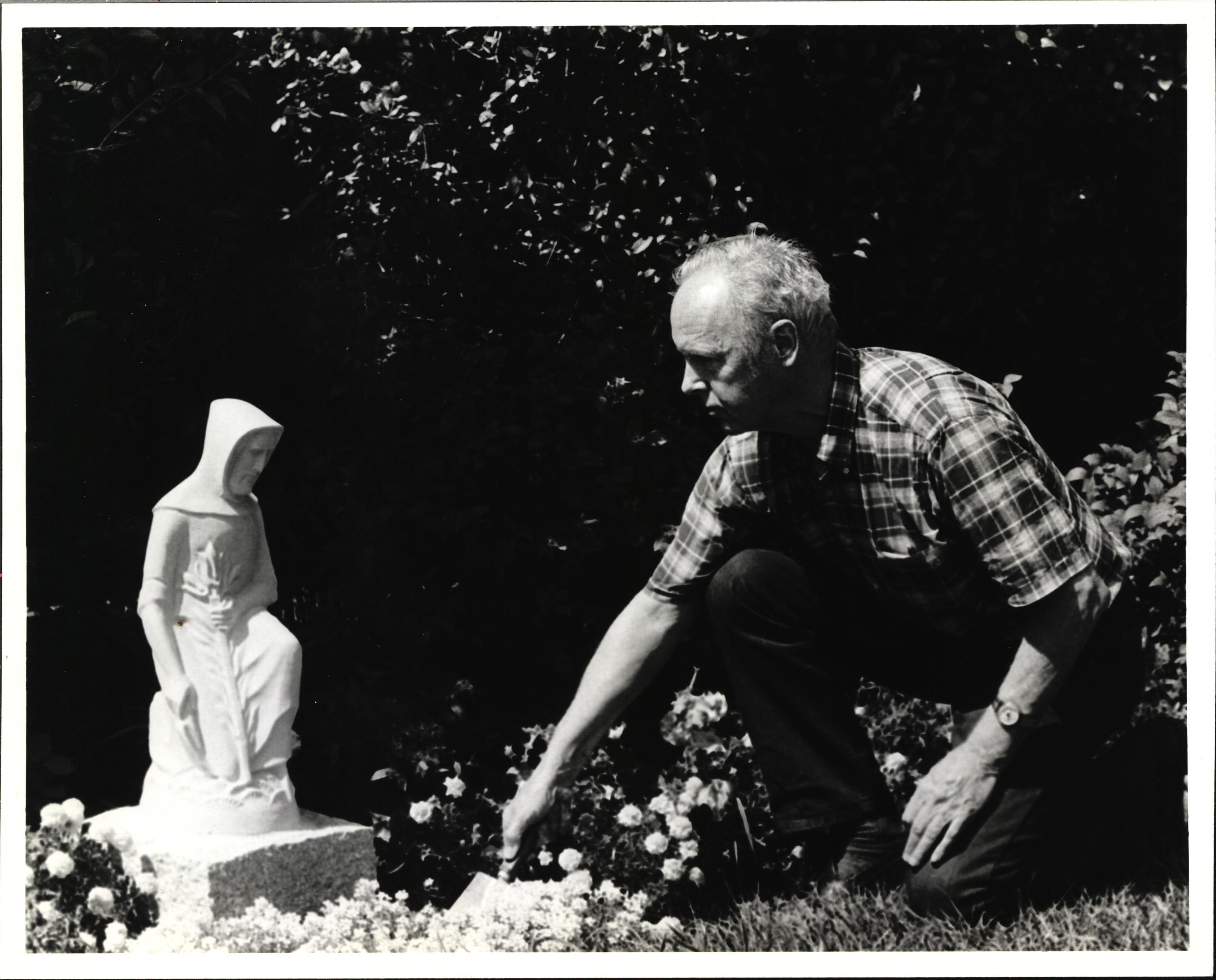 Black and white photograph of Stokes with the Saint Joseph statue, circa 1982