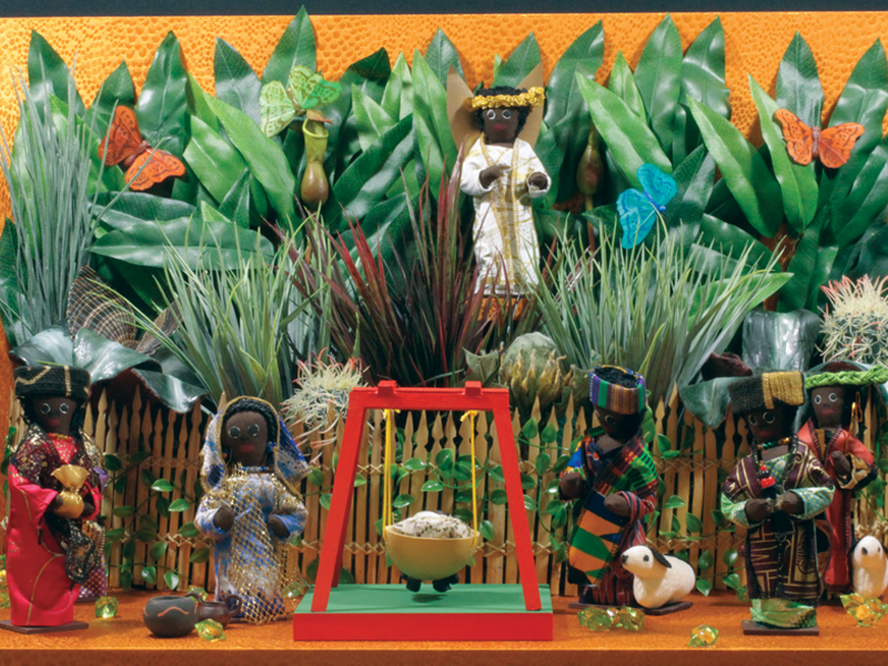 Lush greens and colorful butterflies portray what life in Ghana may have looked like for the Holy Family. The Magi in this Nativity by Joana Lekia Nelson are dressed in colorful garments representative of Ghanaian culture as they visit with gifts in hand.