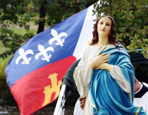 Image of Mary infront of a Mardigra flag 