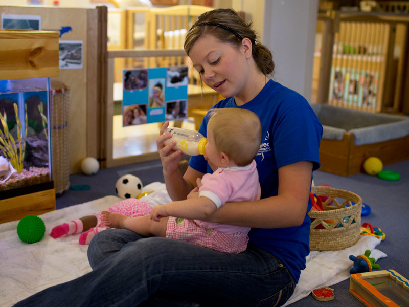 Child and caregiver in an infant classroom