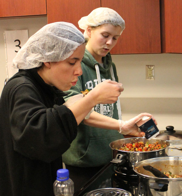 Students cooking in the food lab