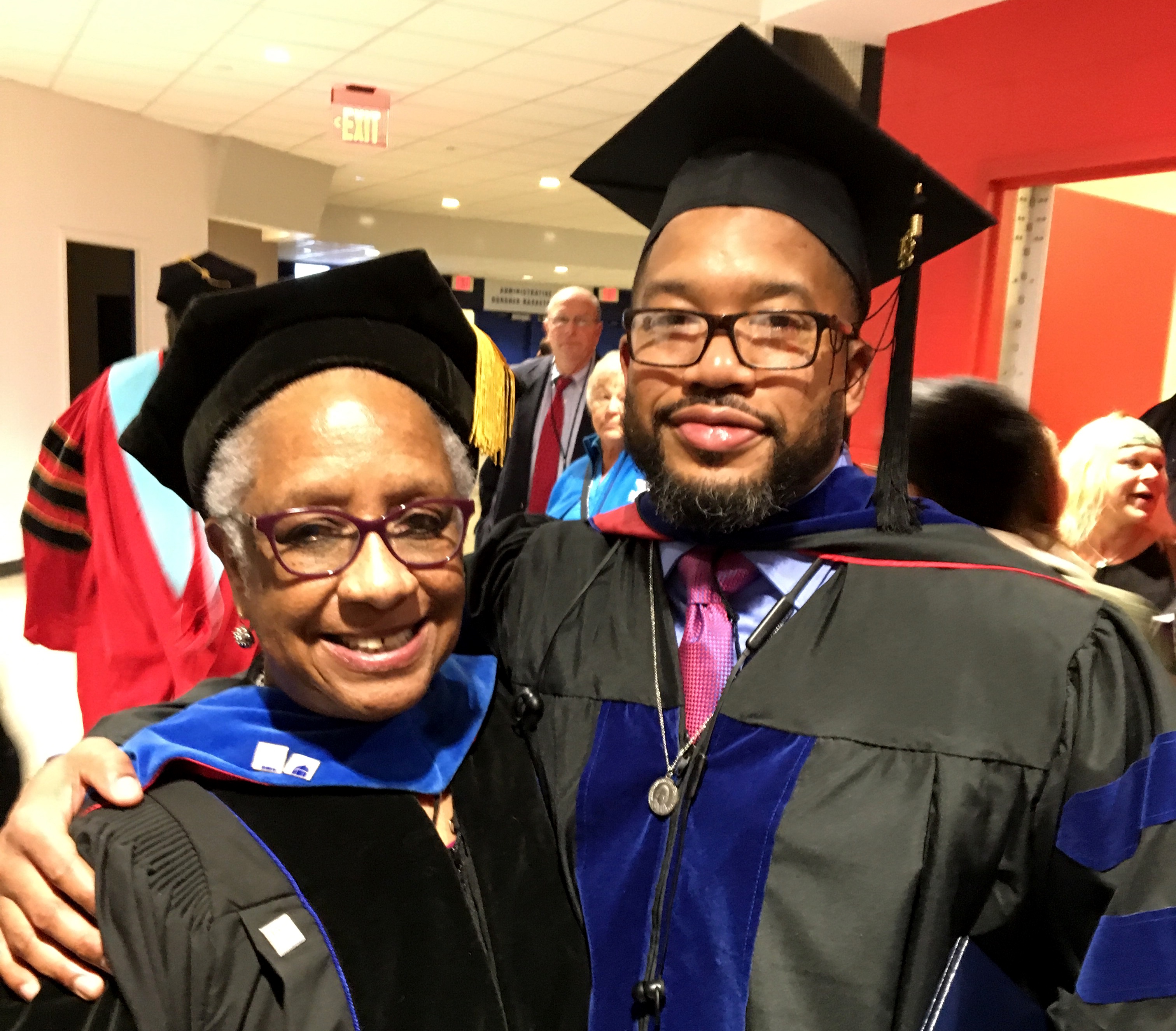 Two graduates celebrate.