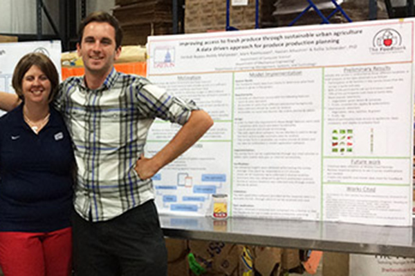 Mark Rasmussen, pictured here alongside Dr. Kellie Schneider, who collaborated on rainwater harvesting and sustainable plant watering systems.
