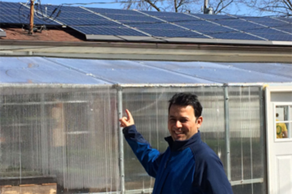 Salahaldin Alshatshati at Mission of Mary Cooperative with solar panels