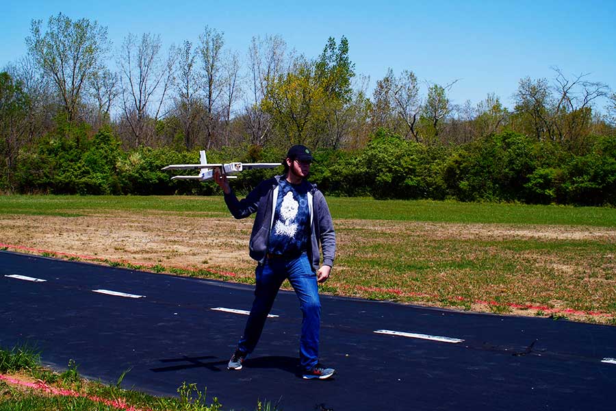 Student getting ready to launch the aircraft on runway.