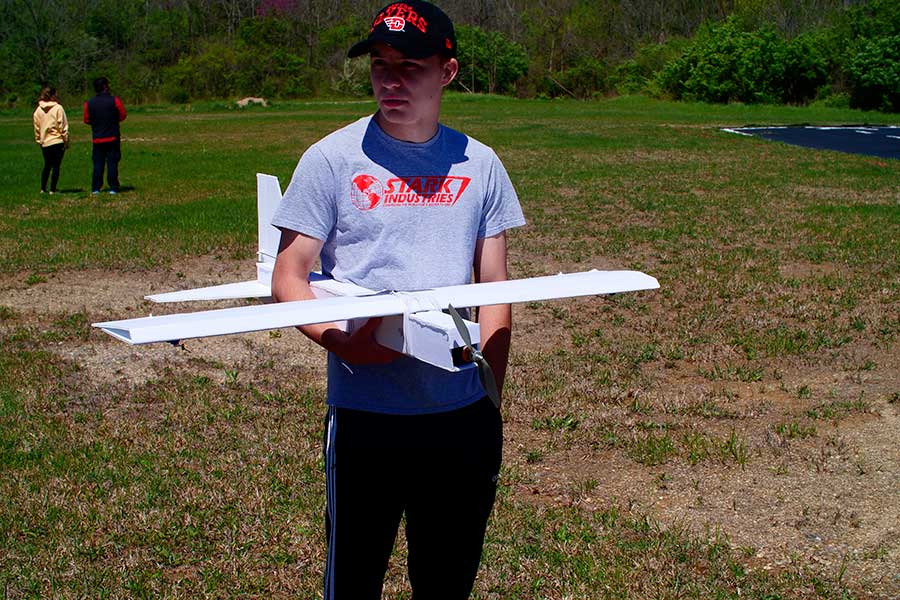 Student waiting in line with his aircraft for its maiden flight.
