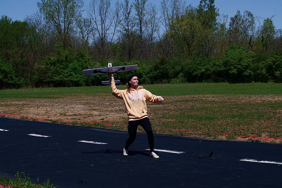 TA of the course built her own RC airplane and launching it.