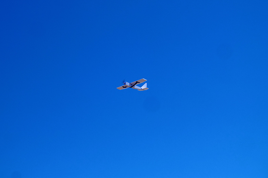 Student RC airplane in flight in beautiful clear blue skies.