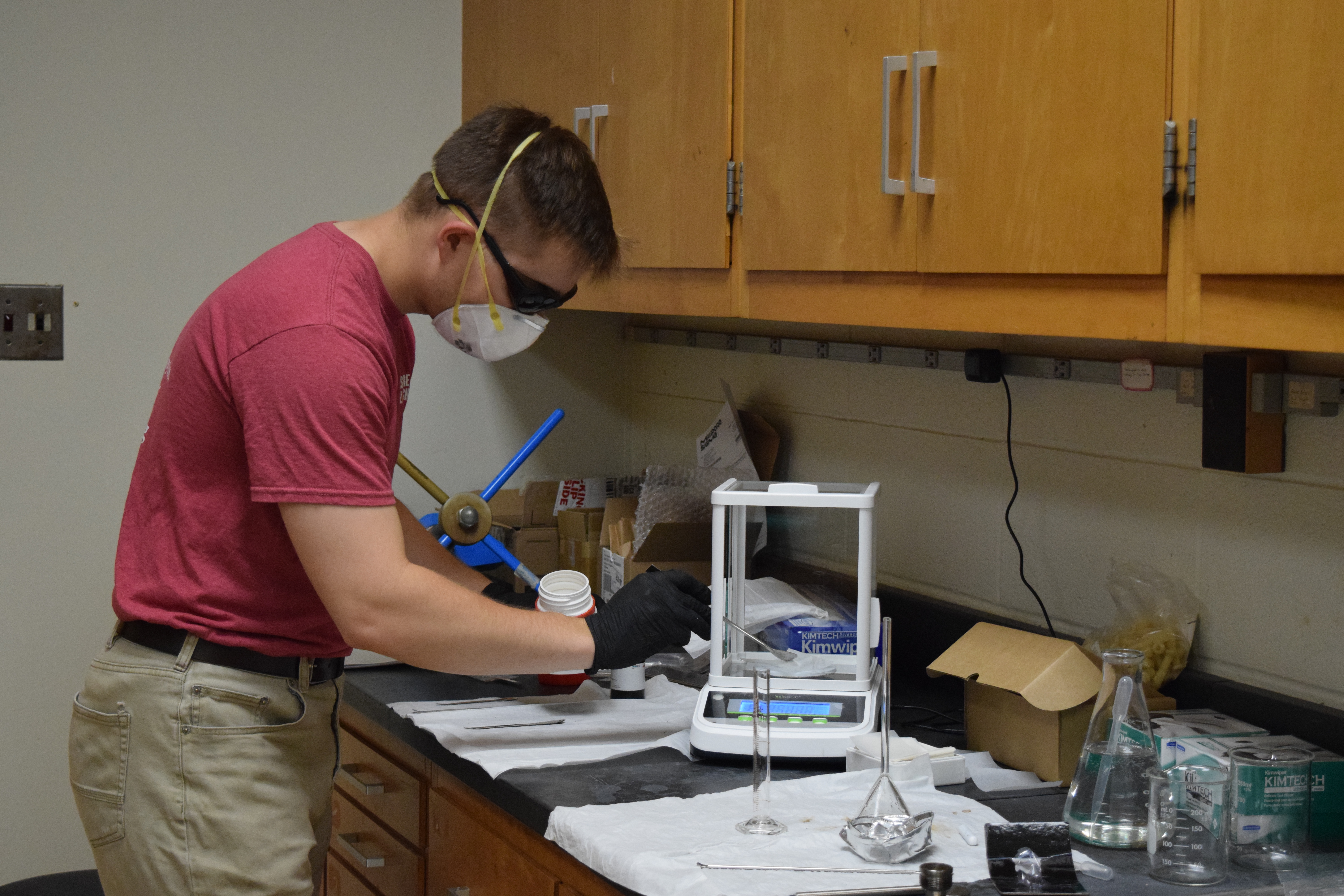 SURE student working with lab equipment.