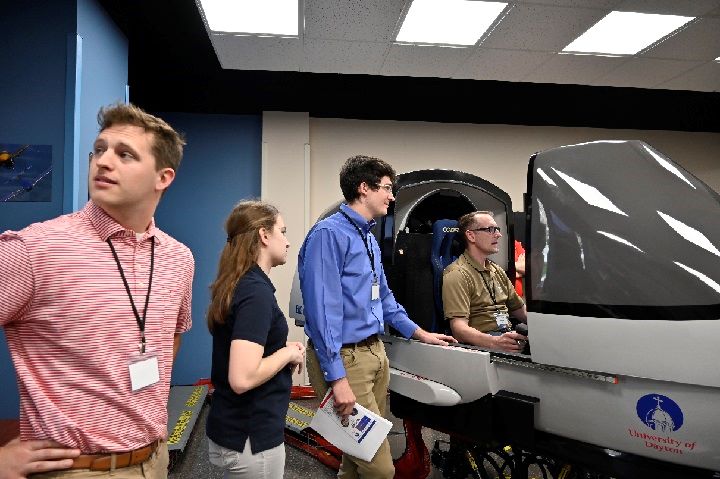University of Cincinnati team with test pilot flying student aircraft design in sim