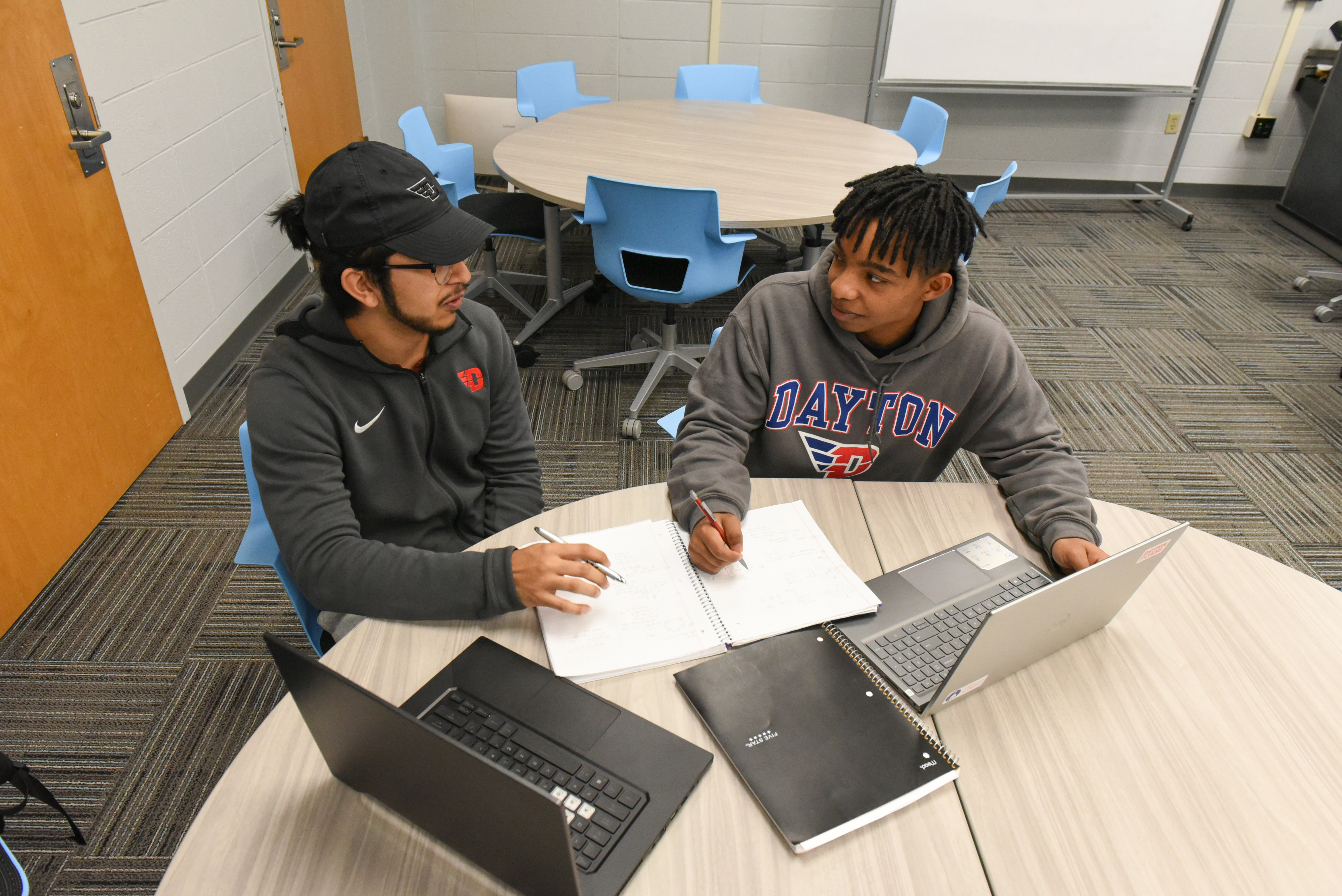Two males students studying together at a table.