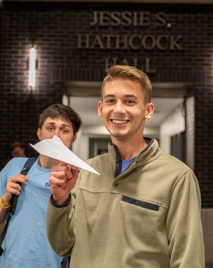 Student holding his winning paper airplane