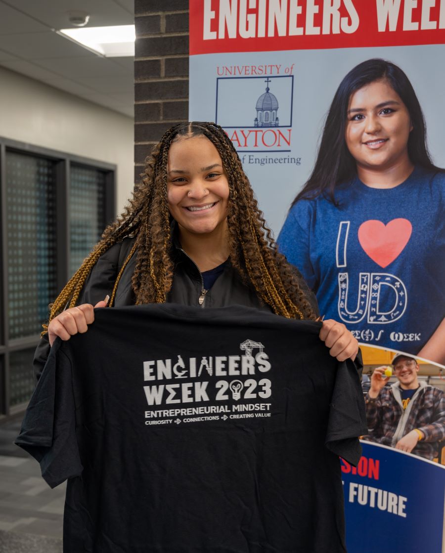 Student proudly displaying E-Week t-shirt