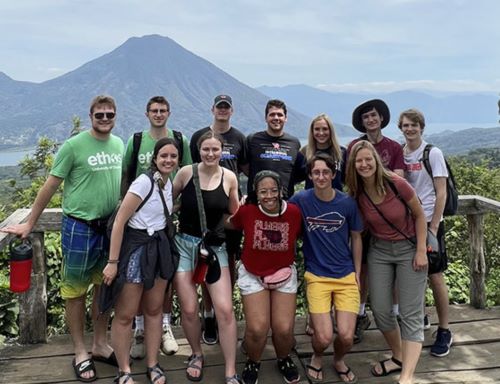 A group of students posing for a photo outside in Guatemala.