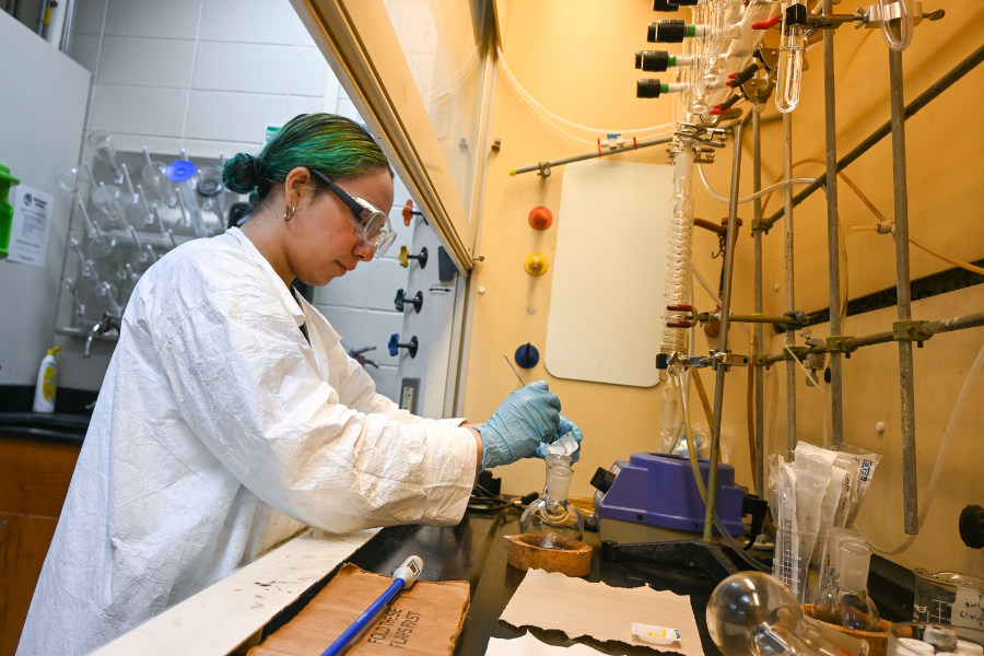 Student working with chemicals in a lab.