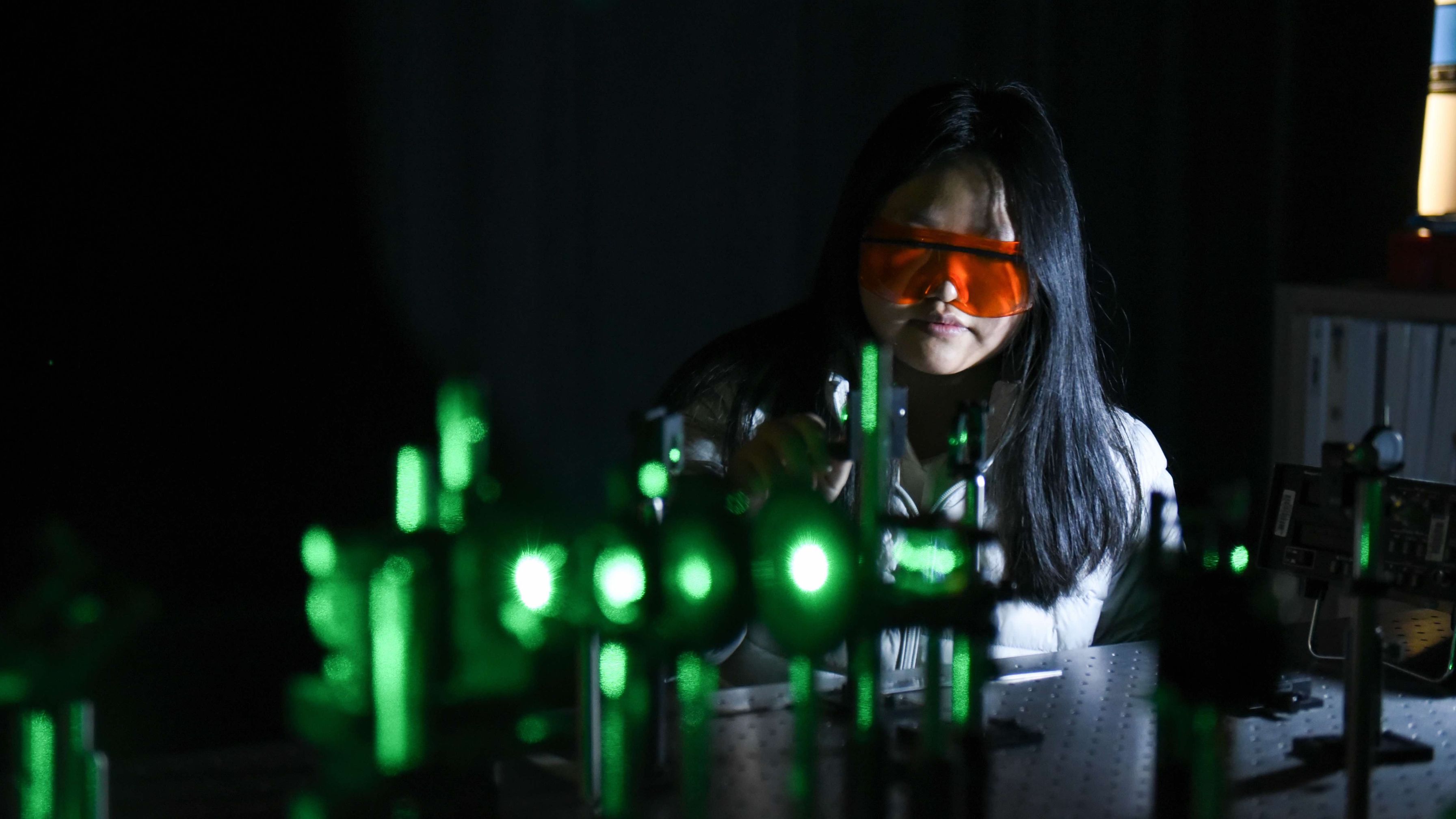 female student using laser machine
